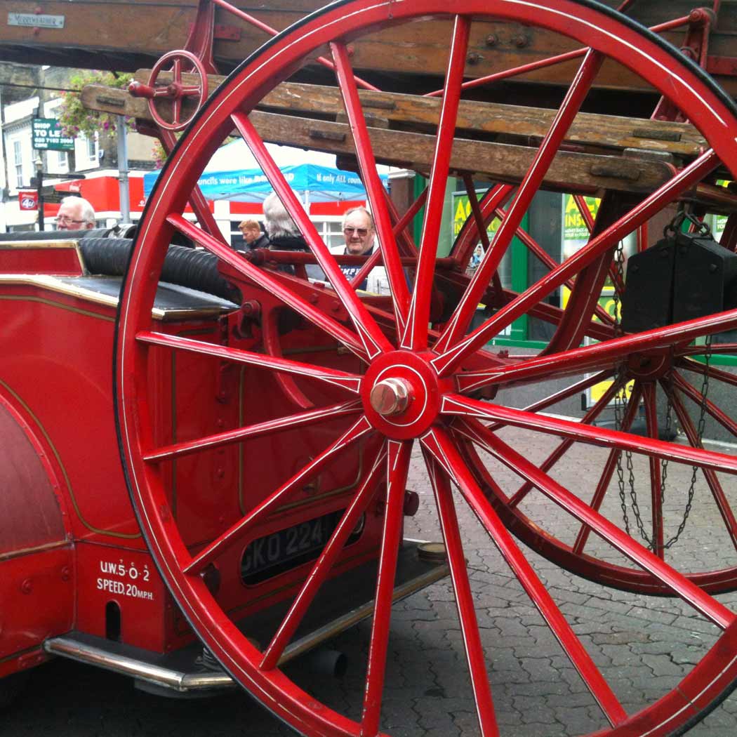 Large, red wheel from an old fire engine. 