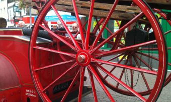 Close up view of an old cart with red wheels at Dartfrod Museum