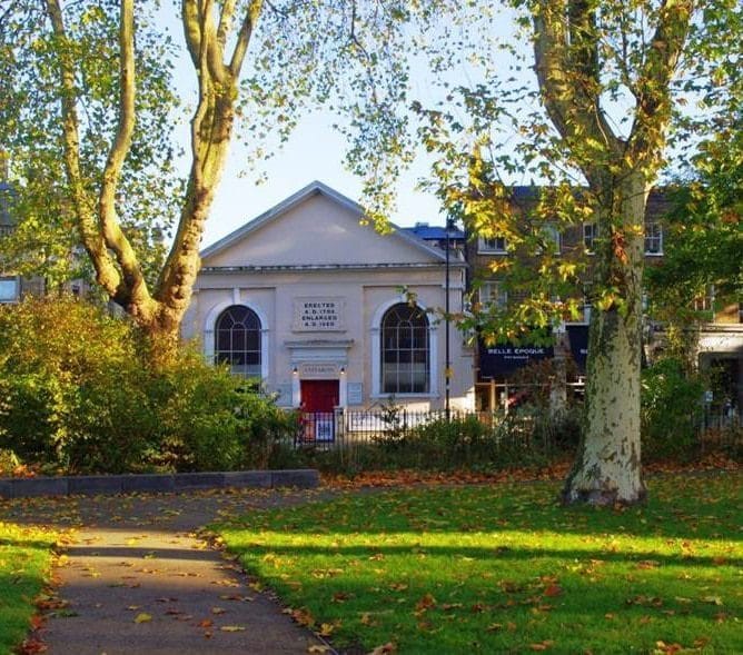 White building, with trees around it.